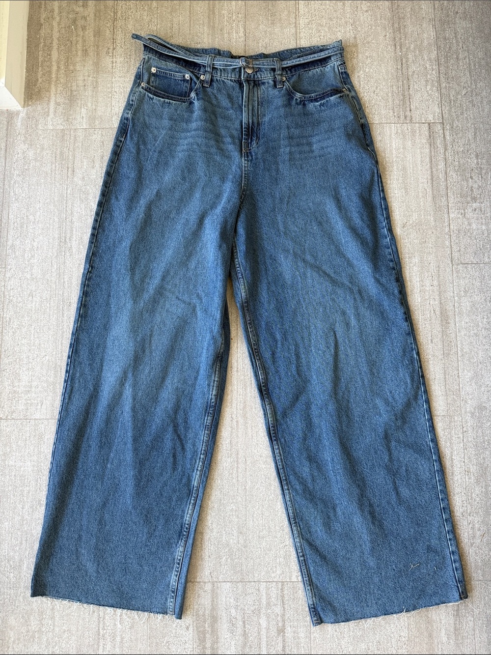 Calvin Klein baggy blue jeans with matching belt and raw hem size 32